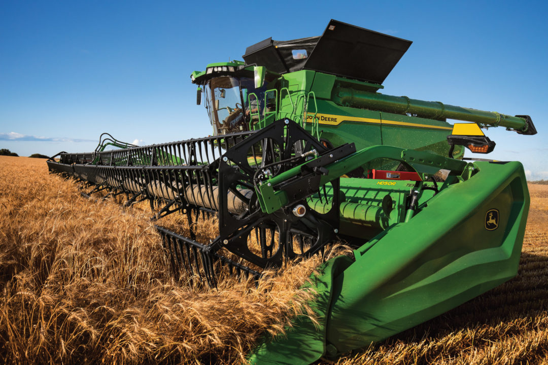 John Deere X Series harvesting wheat